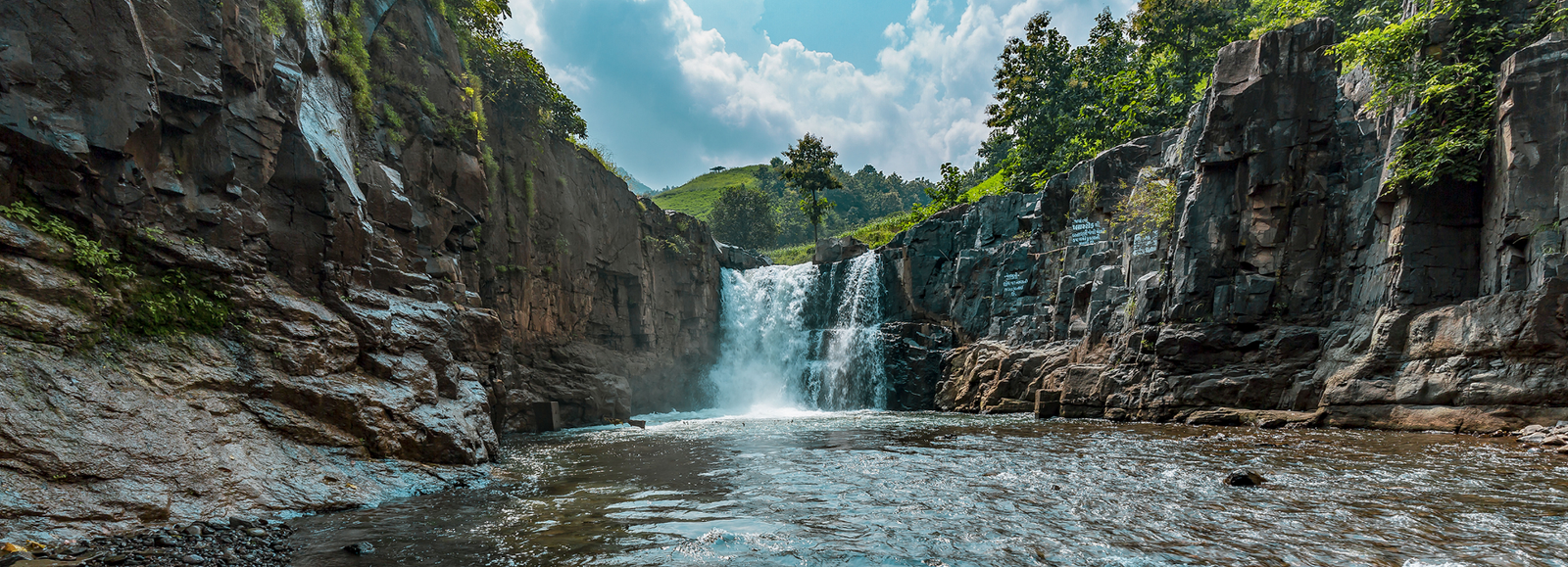 Zarwani Waterfall cascading between rugged rocks and green forest inside Shoolpaneshwar Wildlife Sanctuary, Gujarat