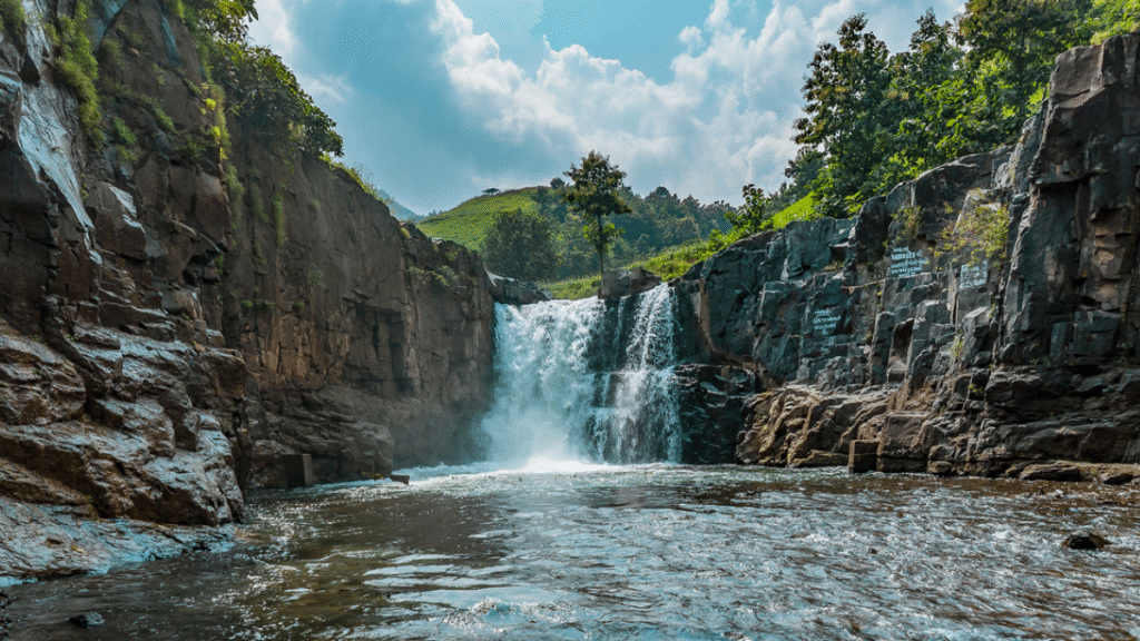Zarwani Waterfall cascading between rugged rocks and green forest inside Shoolpaneshwar Wildlife Sanctuary, Gujarat